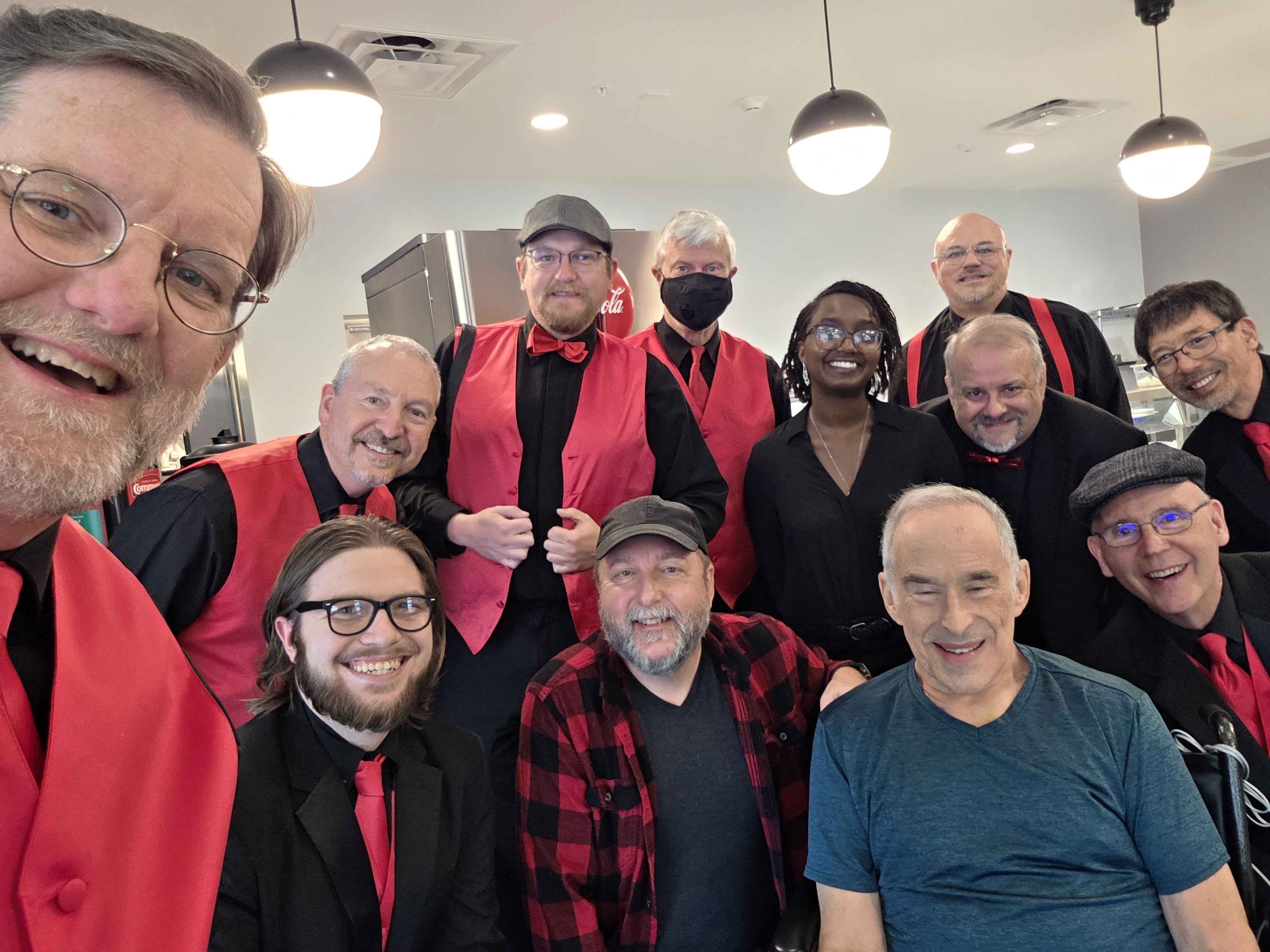 Members of the chorus gathered around member Mike Roth (seated)