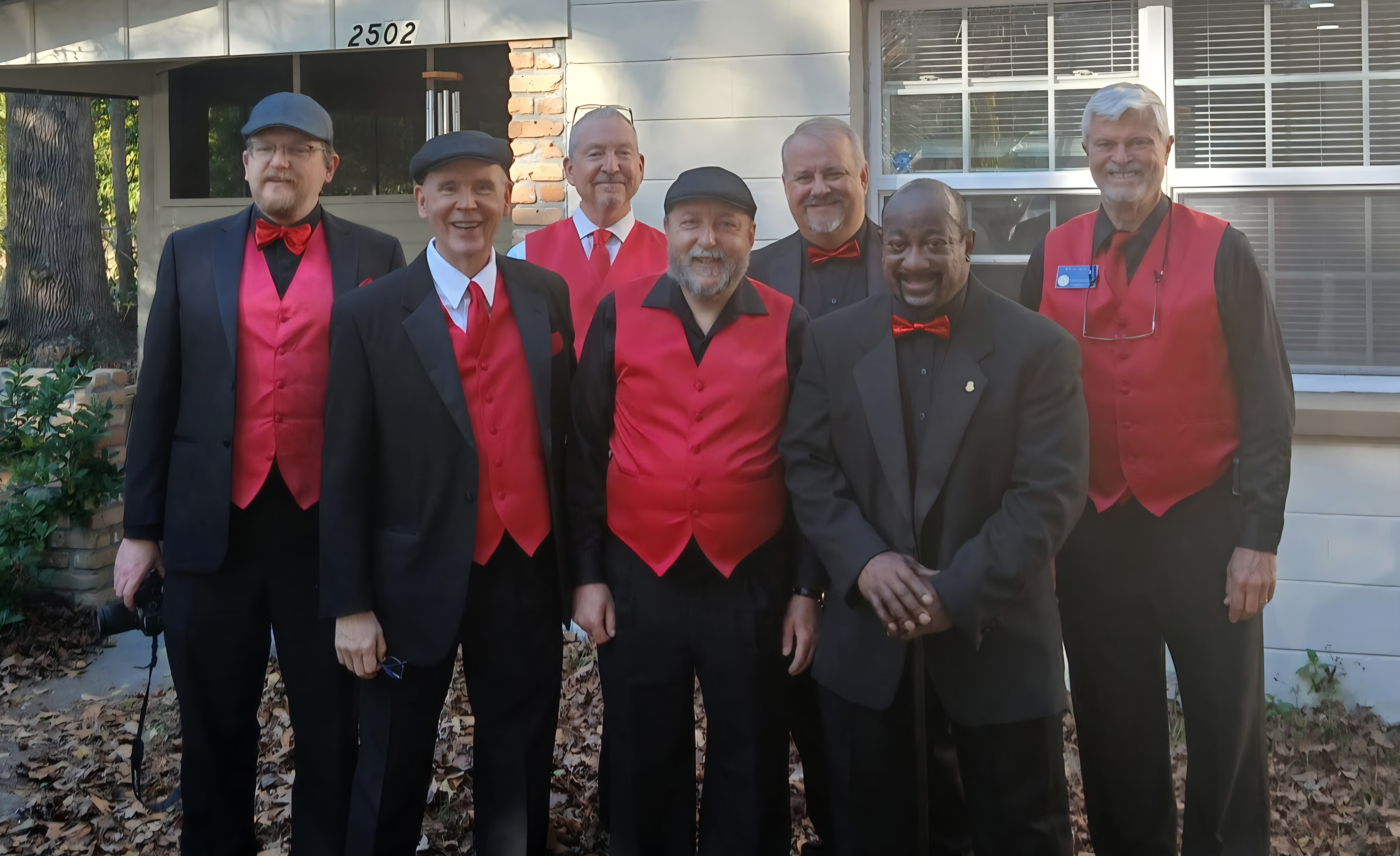Our Friday ensemble posing for a photo in front of a recipient's house.