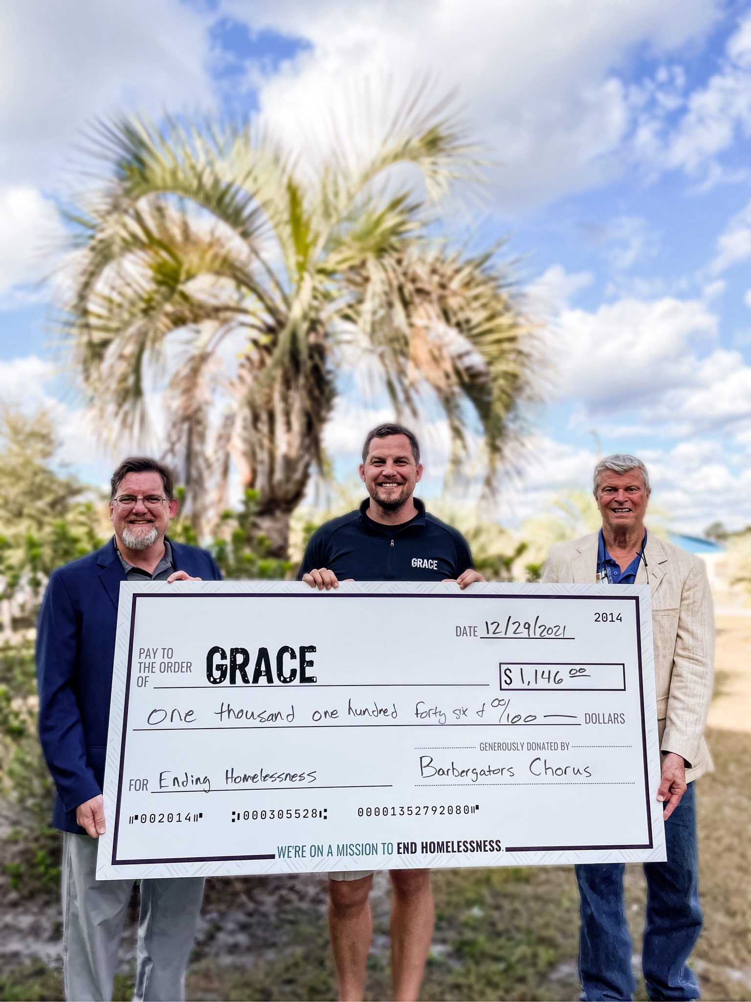 Chorus president, Dave Jacobs, and board member, Steve Black, present big check to Grace Marketplace Director of Advancement, John Thomas.